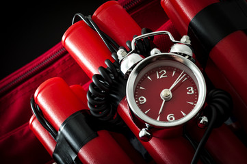 Terrorism and bomb threat concept with dynamite or TNT stick, alarm clock, black wires and a red...