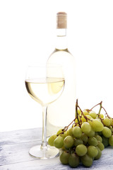 Glass of wine and grapes on wooden background. white wine concept