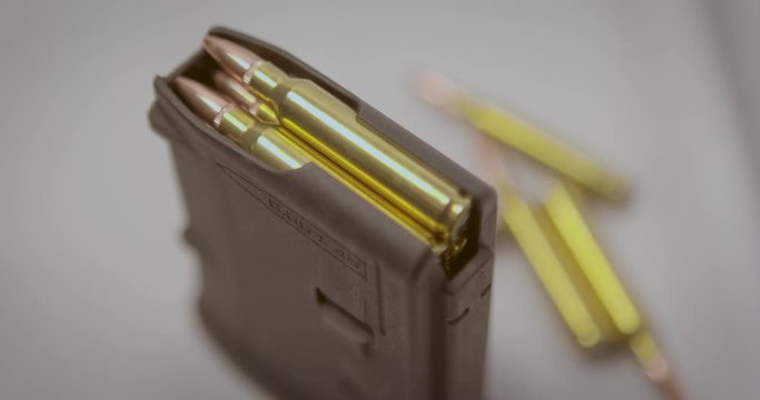 Pull focus shot on a rifle magazine with bullets