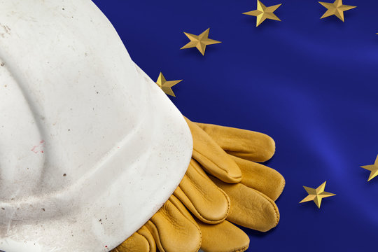 Construction Workers Hard Hat and Gloves on flag of the EU