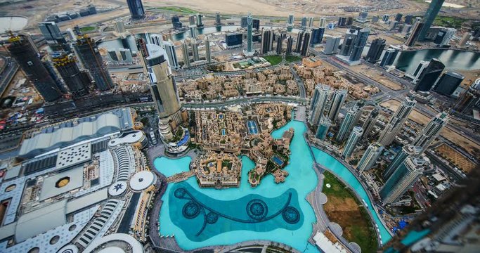 DUBAI, UAE &ndash; MARCH 2016 : Timelapse from Burj Khalifa viewpoint on a sunny day with Dubai Fountain and Downtown cityscape in view