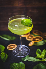 Top view of a floating mint leaf in a cocktail.