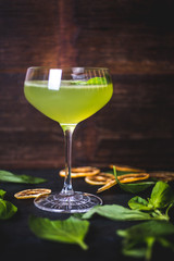 Green cocktail on the background of a wooden background. - 187162881
