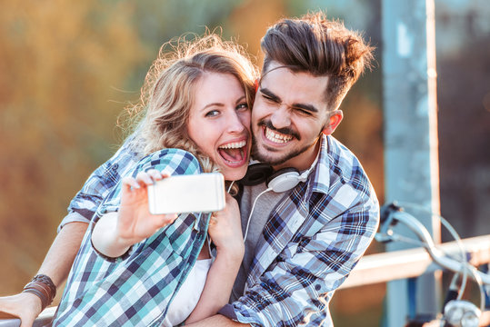 Happy adorable lovers posing for selfie photo