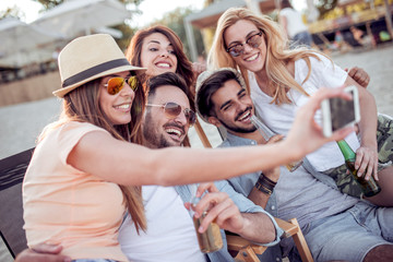 Group of young people take selfie outside