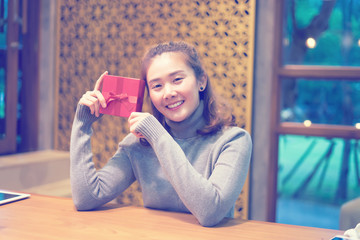 Asian women Hands holding craft paper gift box with as a present for Christmas, new year, valentine day or anniversary