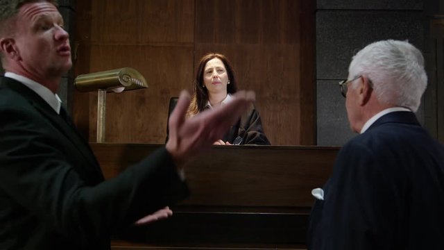 Lawyers in a modern court room arguing a legal case in a judiciary battle in front of a judge