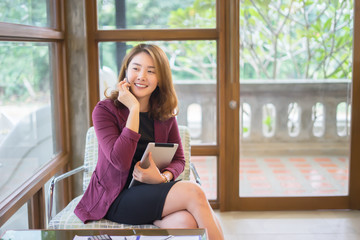 Smiling Business woman working in office with documents,Happy Asian businesswoman using phone...