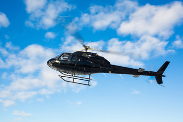 solo black helicopter in blue skies © PhotoSpirit
