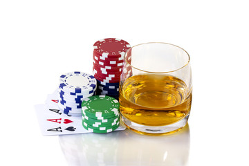 Cards to poker and colorful chips with glass of whiskey