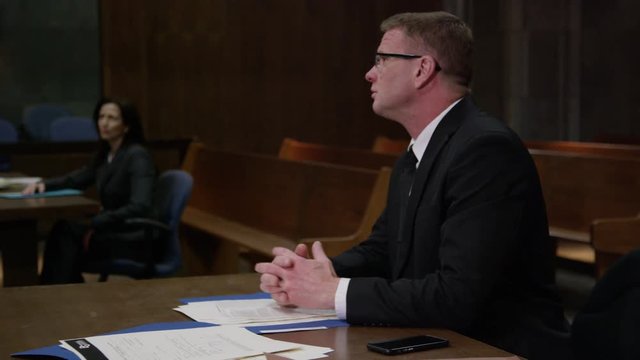 Lawyers in a modern court room arguing a legal case in a judiciary battle in front of a judge