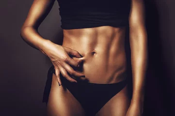 Fotobehang Fitness flat belly woman pinching abs skin © beccarra