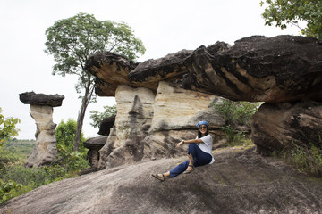 Asian travelers thai women travel and posing at Sao Chaliang or Rock Earth Pillar in Pha T