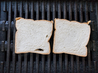 Grilling a white breads on a stove close up.