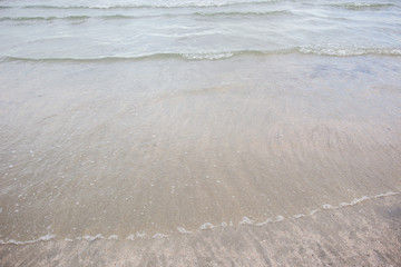Small wave of sea water at the beach close up background.