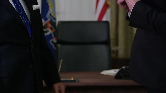 Corruption in politics - man being paid by special interest group in oval office washington white house