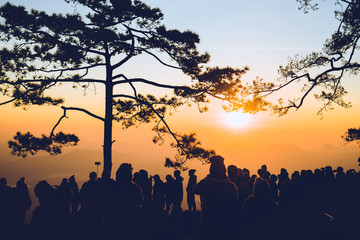 People watching Sunrise in the morning. Tourists travel relax in the holiday. photograph sunrise in the morning among people. Thailand