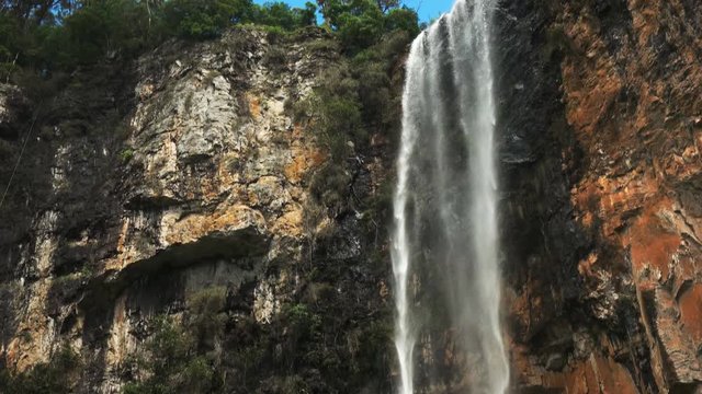 low angle tilt down shot of purlingbrook waterfall in springbrook national park
