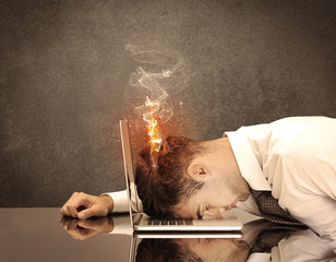 Sad business person's head catching fire