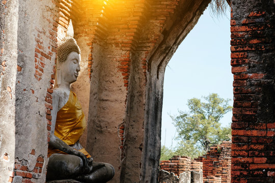 Ancient Buddha and old brick wall on ancient monuments that are over 200 years old. Wat Nakhon Luang Tample,Prasat Nakhon Luang public domain or treasure of Buddhism in  Ayutthaya, Thailand