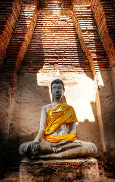 Ancient Buddha and old brick wall on ancient monuments that are over 200 years old. Wat Nakhon Luang Tample,Prasat Nakhon Luang public domain or treasure of Buddhism in  Ayutthaya, Thailand