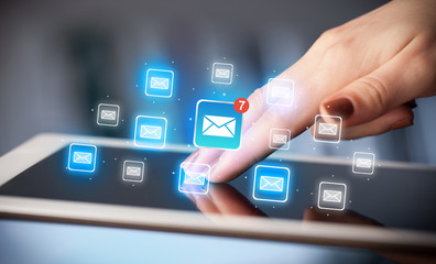 Fingers touching tablet with mail
