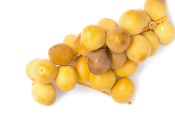 Fototapeta na wymiar yellow raw dates isolated on white background