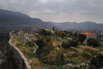 Mountain landscape with hills, old wall and vintage building