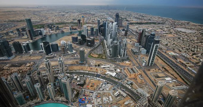 DUBAI, UAE – MARCH 2016 : Timelapse from viewpoint on a sunny day with cityscape and ocean in view