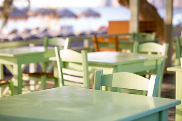 Tables and chairs in a street restaurant in Kamari on Santorini