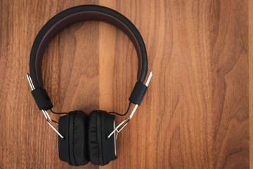 Smartphone and headphone on wooden background for listen to music