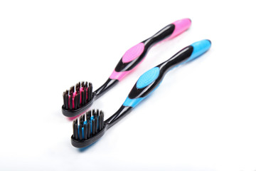 Two toothbrushes Black and pink black and blue isolated white background.