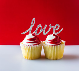 Read and white cupcakes with text love on red and white background.  