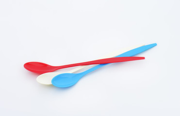 Three long plastic spoons