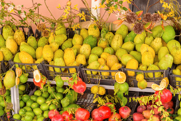 italian citrons at the market with lemons and pomegranate, sicily, italy