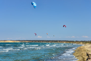 Kite surfers in a windy bay n an aegean island of Turkey