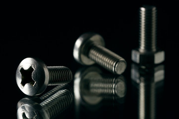 Metal bolt and screw close-up with reflection and bright texture