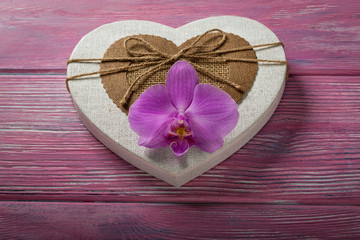 Gift box in the shape of a heart and Orchid