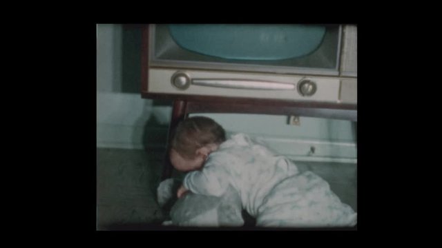 R8_22 Cute little boy checks out antique television set