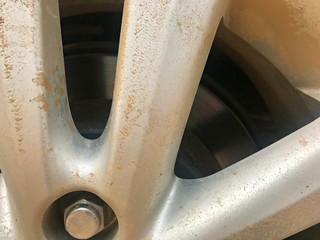 Look through the car front brake shoe with muddy alloy