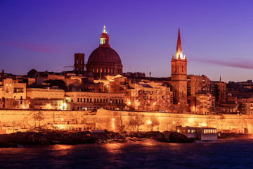 Fototapeta na wymiar Valletta, Malta: skyline from Marsans Harbour at sunset. The cathedral
