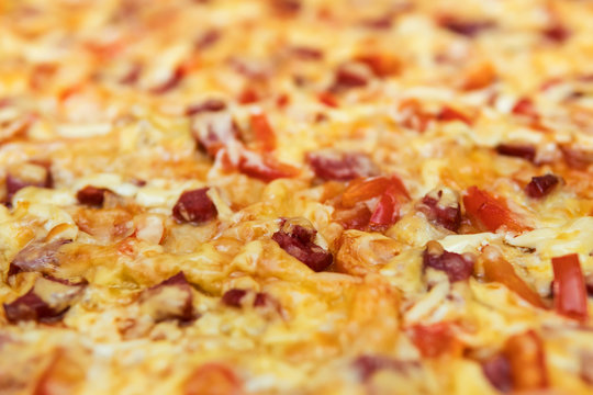Background of pizza with shallow depth of cut, close-up