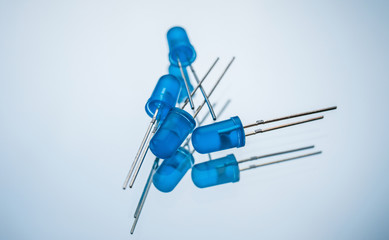 blue light emitting diode on white background. active electronic element. creates optical radiation