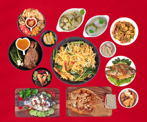 Food is sacred in the Chinese new year, such as fish, pork, shrimp, crab, bamboo shoots, tofu, desserts and fried yellow noodle in  Chinese style placed on red velvet cloth.