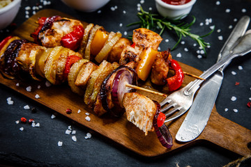 Kebabs - grilled meat and vegetables on white background