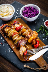 Kebabs - grilled meat and vegetables on white background