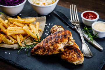 Grilled chicken breast, French fries and vegetables