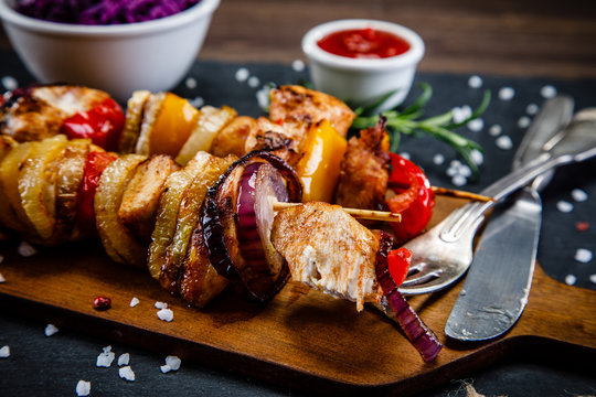 Kebabs - grilled meat and vegetables on white background