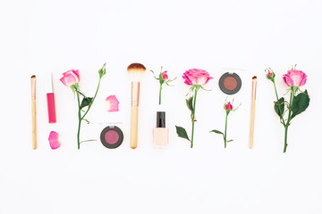 Beauty composition with pink roses and cosmetics on white background. Flat lay, Top view.