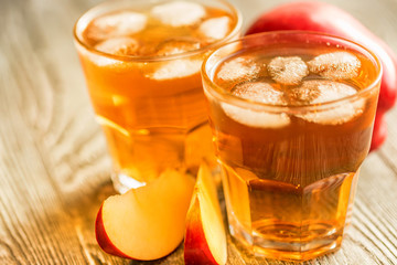 Fresh apple juice or cider in glasses on table